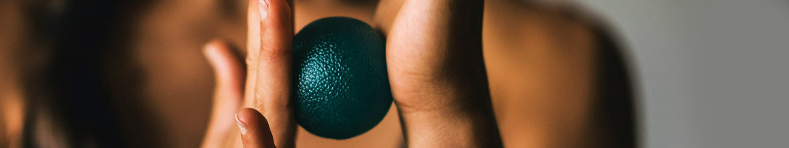 Green ball between hands