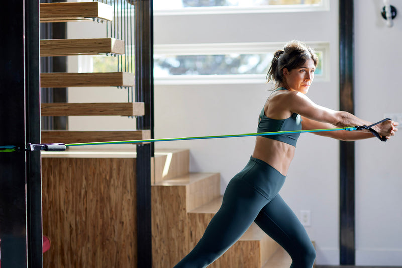 Woman completing Ryan West's 5-Day Resistance Band Workout Schedule