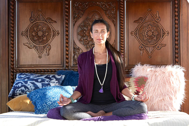 Meaning Behind Malas - Woman meditating with mala