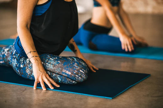 yoga girls do upward pigeon pose on their mats