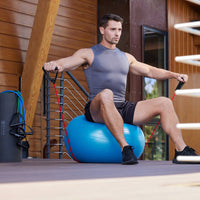 Person sitting on the Balance Ball while using a resistance cord