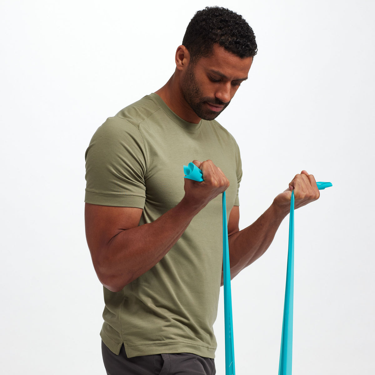Person standing while holding a band from the Restore Strength & Flexibility Kit 