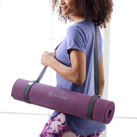 Person carrying a mat with the Gaiam Easy-Cinch Yoga Sling