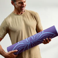 Person holding the rolled Purple Lotus Mat 