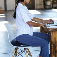 Person seated on Balance Disc