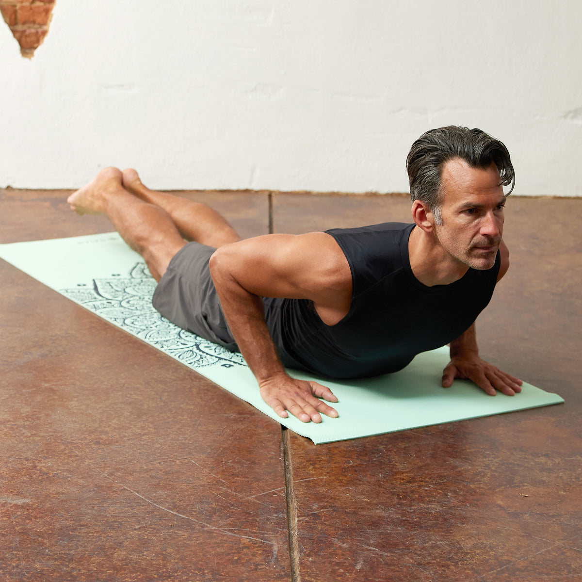 Person in Cobra Pose on the Mandala Sundial Yoga Mat