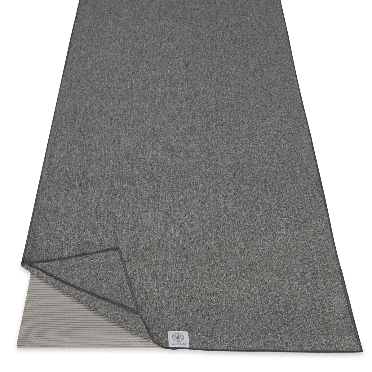 Gaiam Active Dry Yoga Mat Towel Black on mat corner folded back