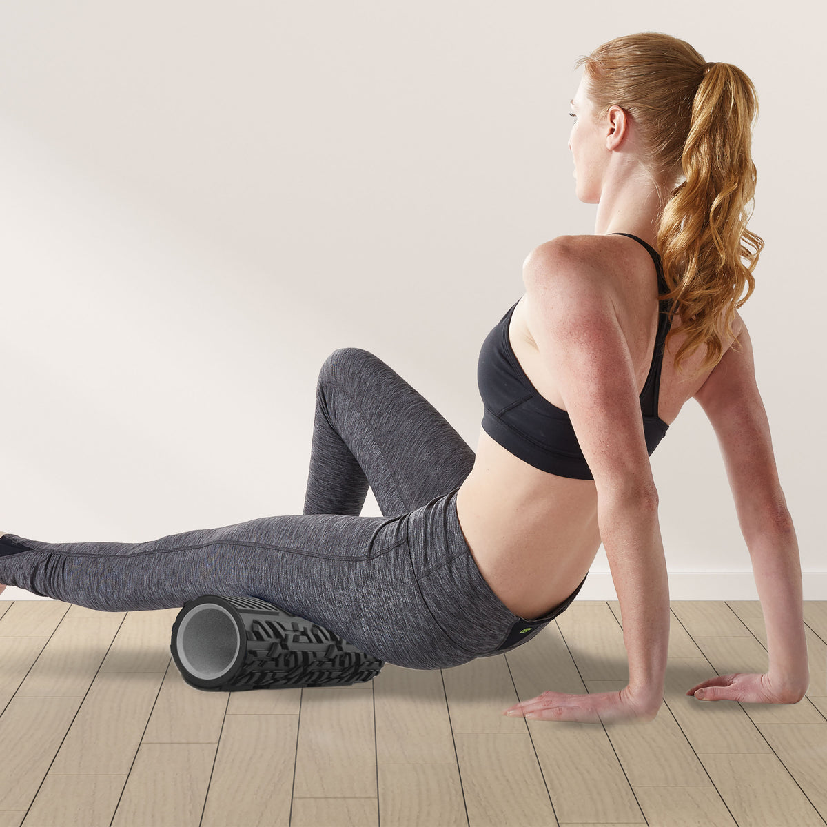 Restore Deep Tissue Performance Roller under the upper leg as it is extended to massage