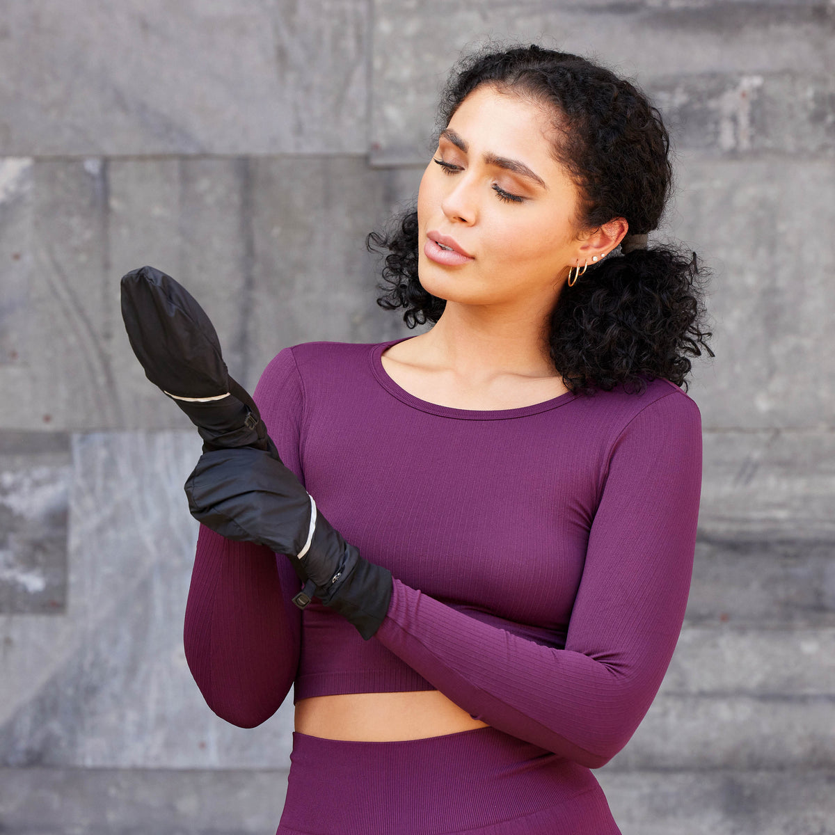 Person putting on the Women's Lightweight Convertible Running Gloves
