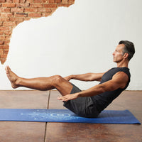 Person in Boat Pose on the Premium Celestial Blue Yoga Mat