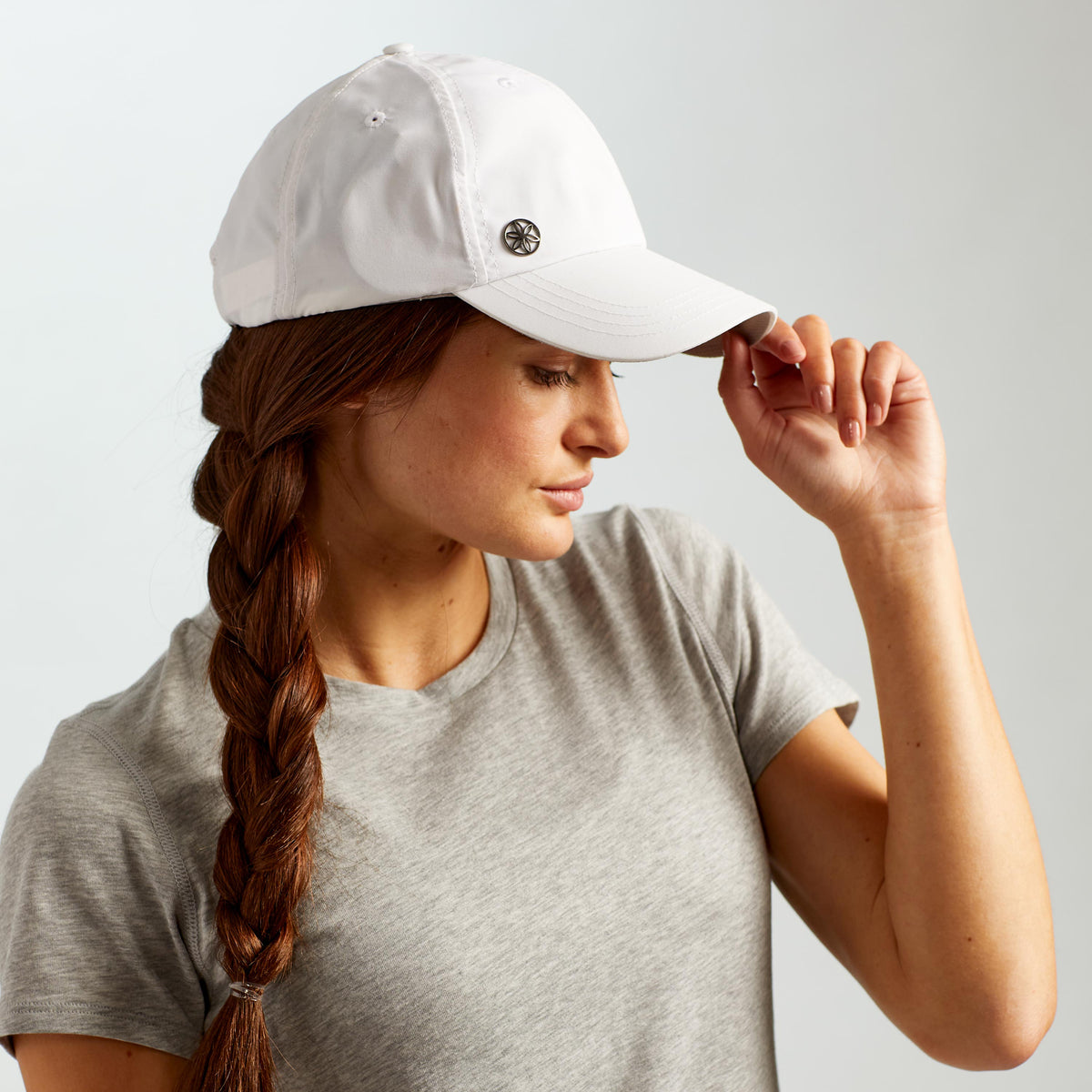 Up close of person wearing the Classic Solara UV Protection Fitness Hat in white