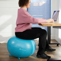 Person sitting on the No Roll Balance Ball in blue