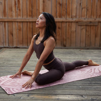 Person doing forward facing yoga pose on ground