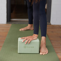 Yoga block with hand on top in stretch 