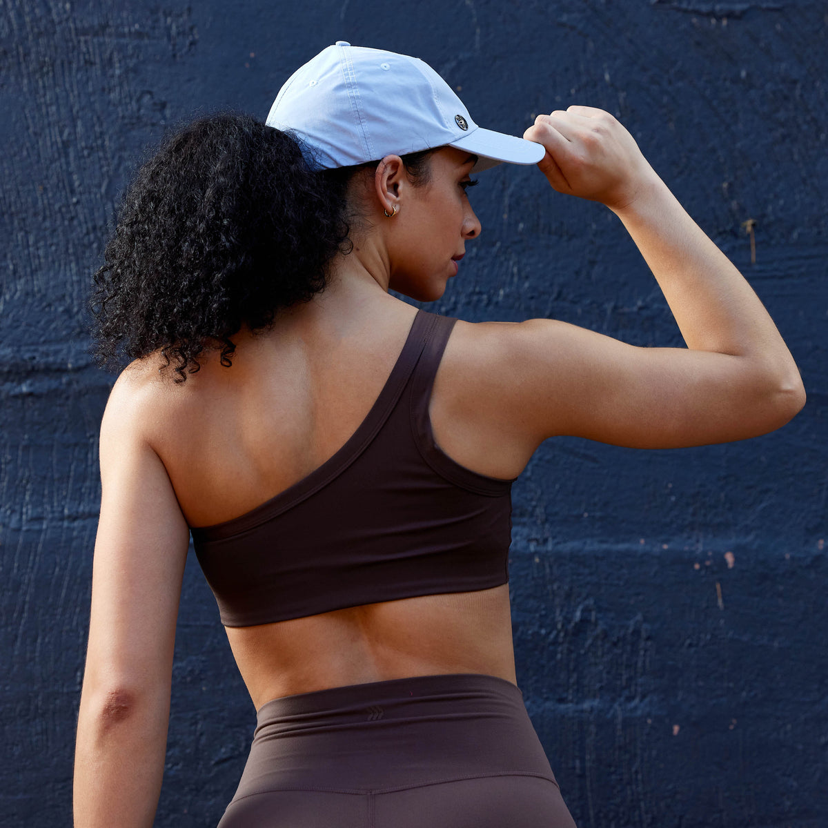 Person showing the ponytail space of the Classic Fitness Hat