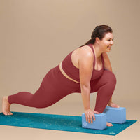 Person using 2 POPSUGAR Yoga Blocks under hands to help stabilize while doing a Lunge