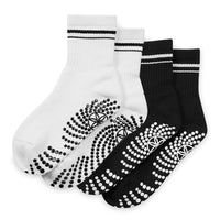 Pair of black and white socks with textured sole on a white background