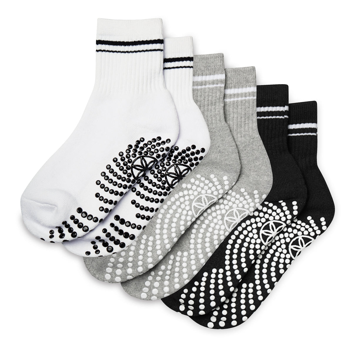 Set of five pairs of socks with non-slip patterns on a white background