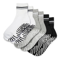 Set of five pairs of socks with non-slip patterns on a white background