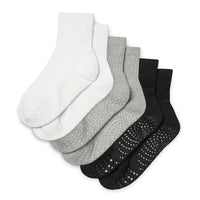 Set of five pairs of socks in white, gray, and black on a white background