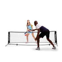 2 people inside playing Pickleball with the Fila Complete Half-Court Pickleball Set