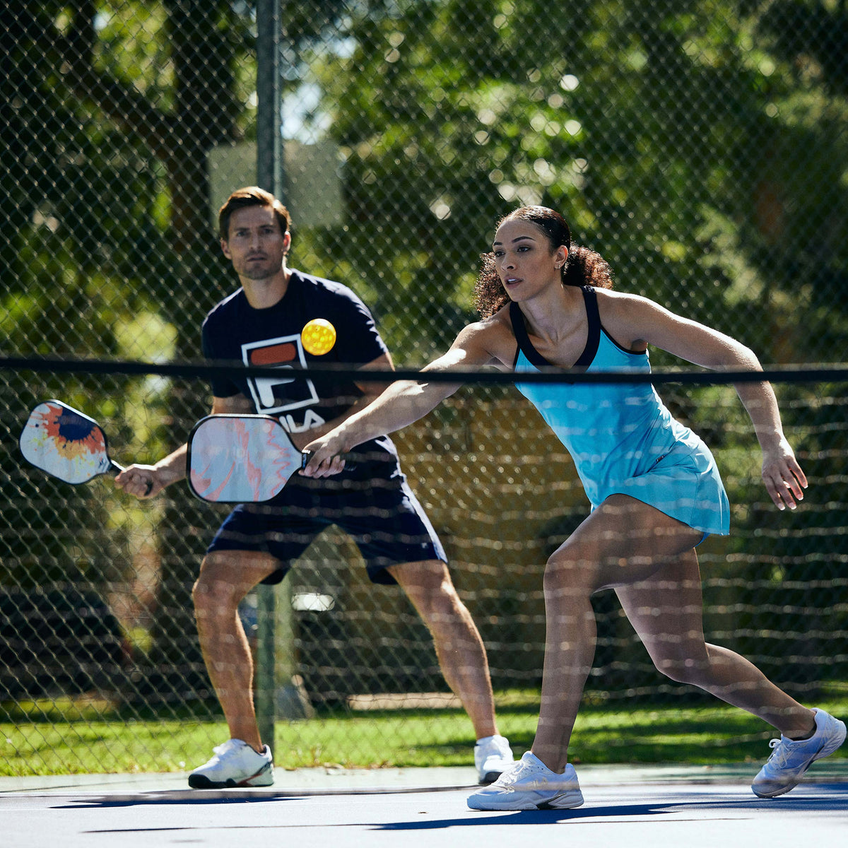 Two people playing Pickleball