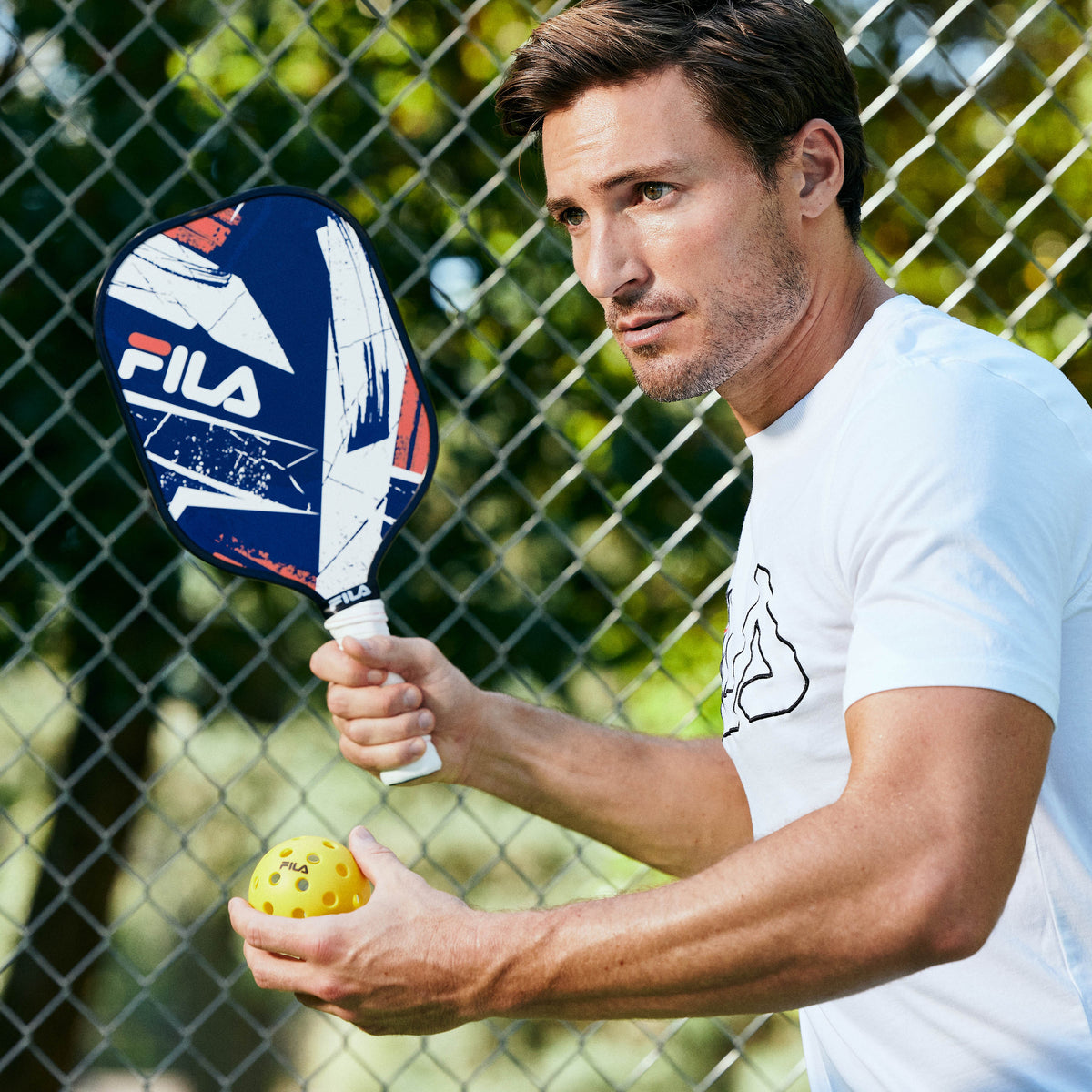 Person holding the FILA Fiberglass Paddle -Action getting ready to hit the ball