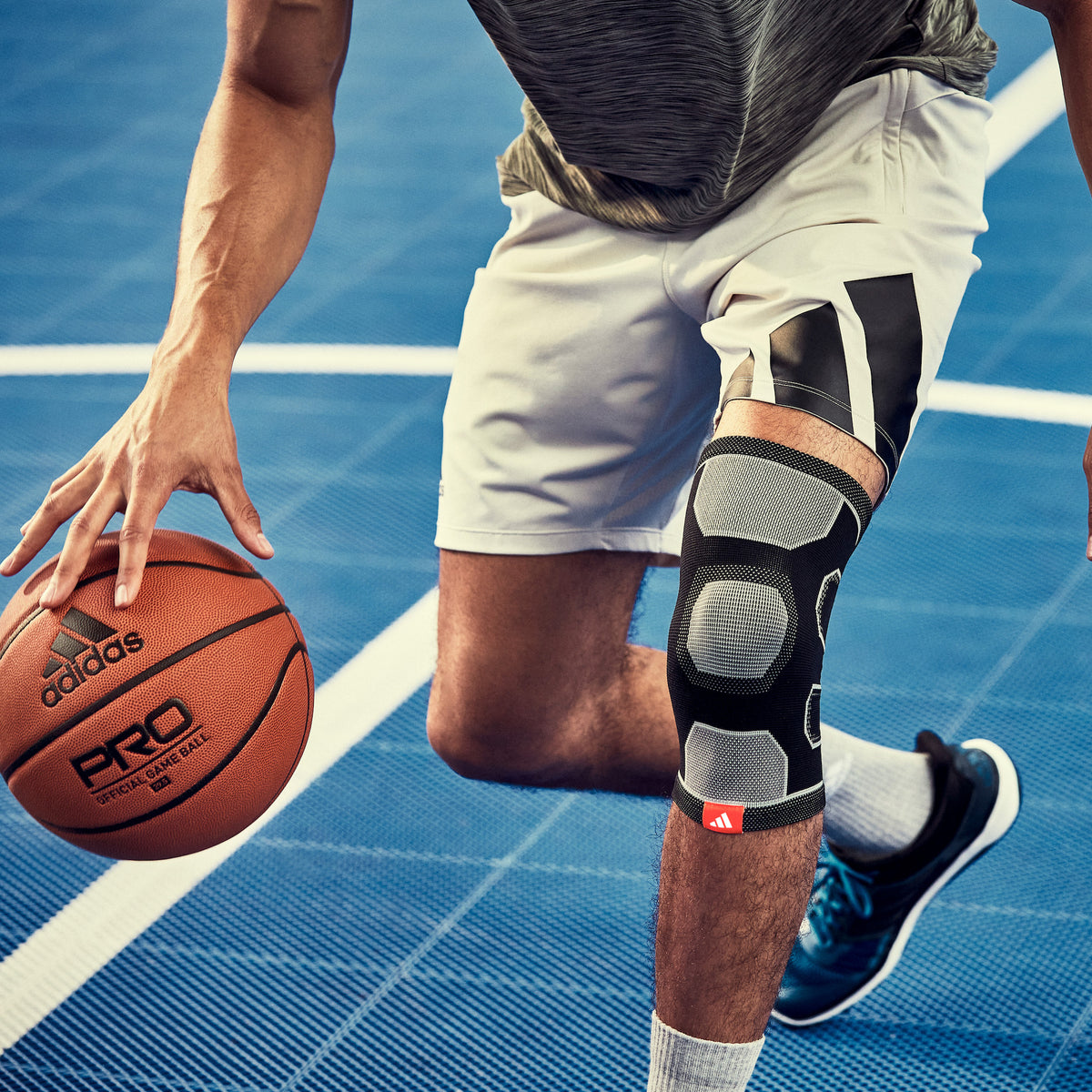 adias Premium Knee Support on man playing basketball