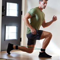 Person doing a Lunge while wearing the Xercuff.