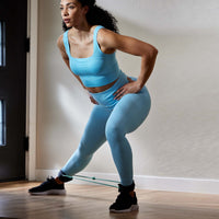 Person doing a Side Lunge while wearing the Xercuff 
