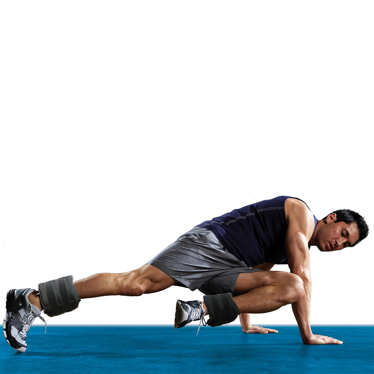 Man in alternating mountain climber position with ankle weights