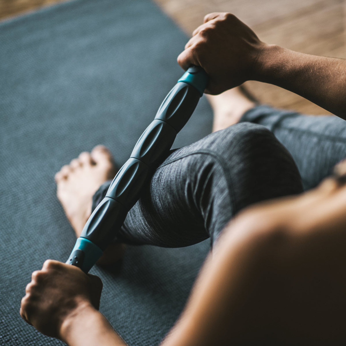 Massaging the lower leg with the Restore Total Body Massage Roller