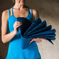 Folded up and compact Blue Sundial Yoga Mat