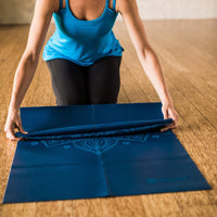 Folding up the Blue Sundial Yoga Mat