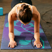 Person in four-arm plank on Premium Lily Shadow mat
