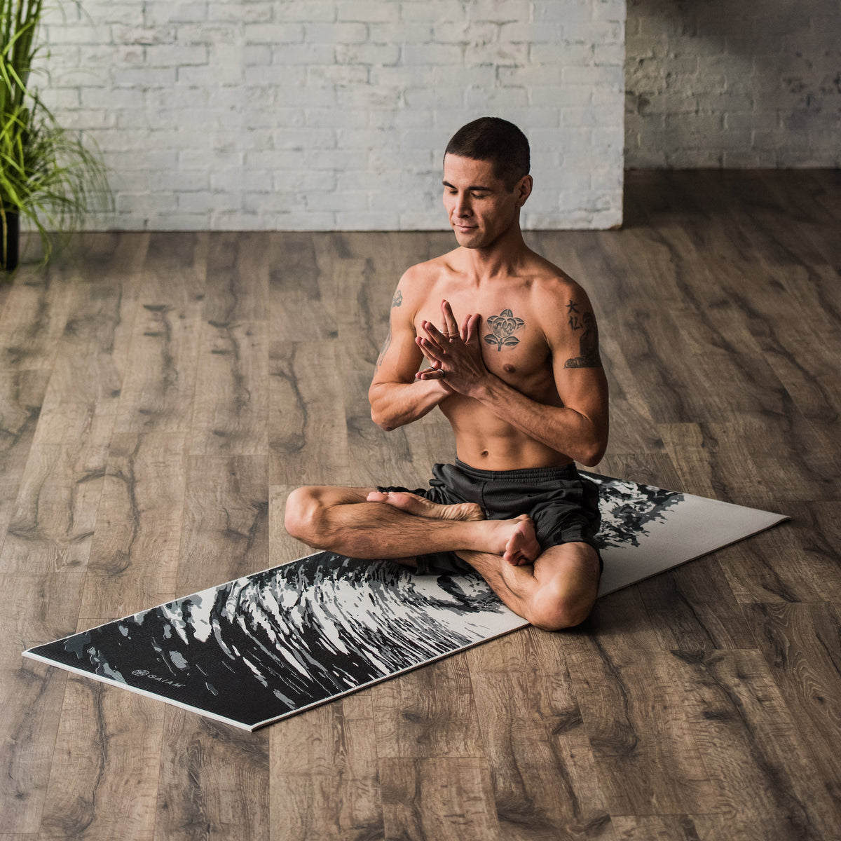 Person sitting on yoga mat 