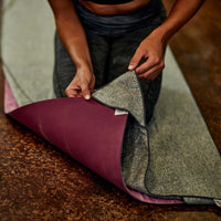 Person putting corner of yoga mat into pocket for Active Dry yoga mat towel