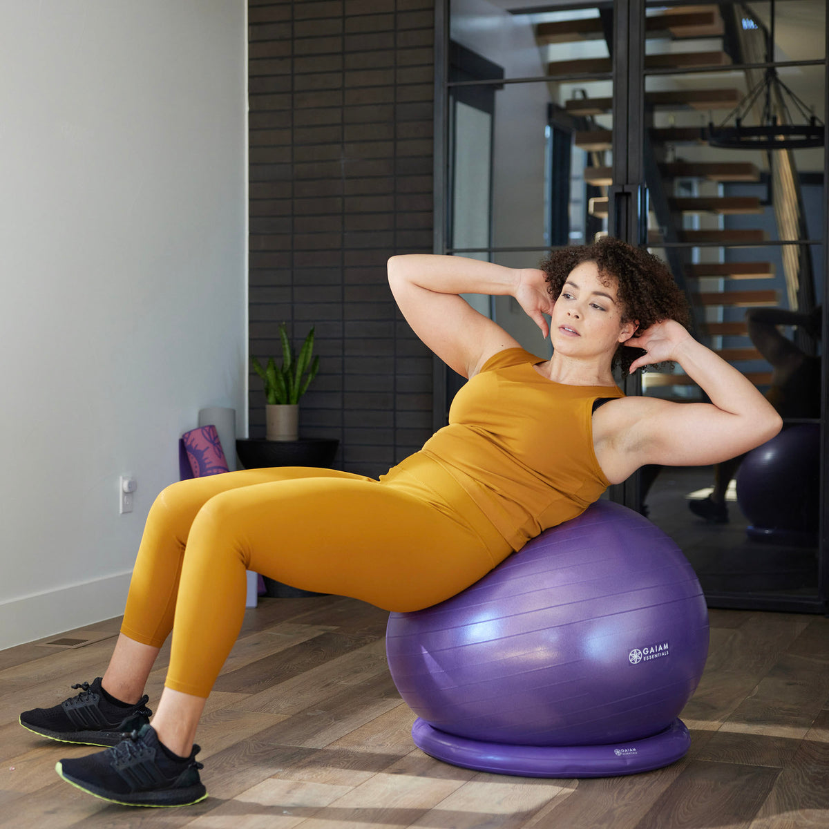 Woman doing crunches on Essentials Balance Ball and Base
