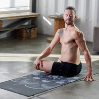 Person sitting on Mystic Ink Yoga mat