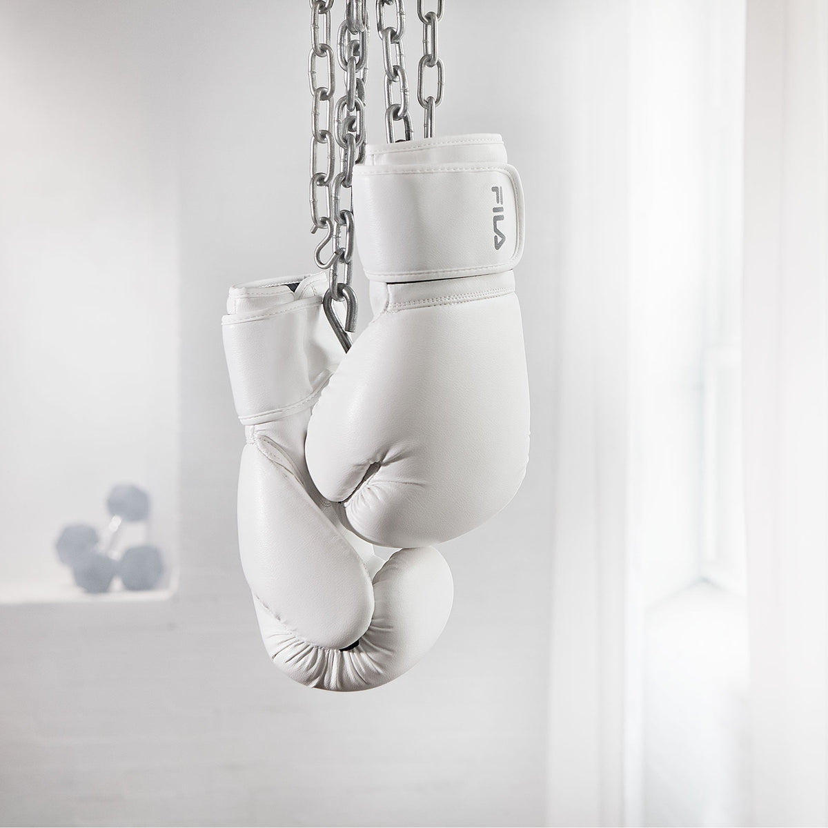 white boxing gloves hanging from ceiling