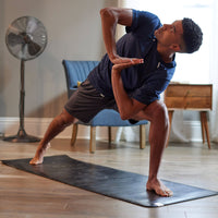 Man in extended side angle on yoga mat
