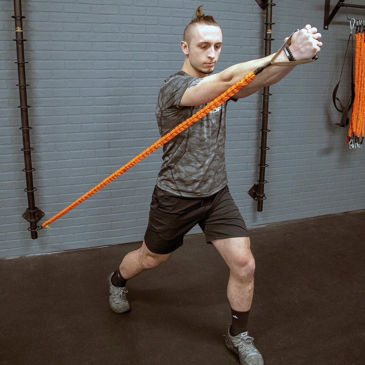 man using resistance band attached to Stroops Mini Spine